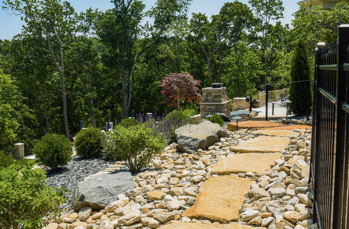 Rock path with flagstone steppers leading to stone firepit terrace, naturalistic hardscape